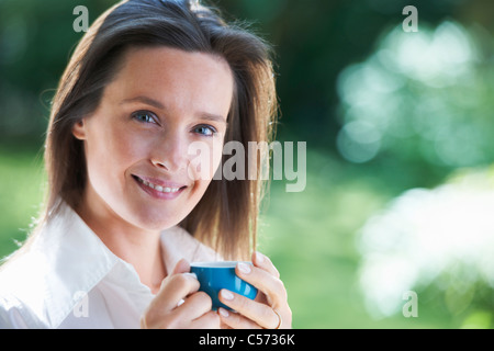 Woman having cup of coffee outdoors Stock Photo