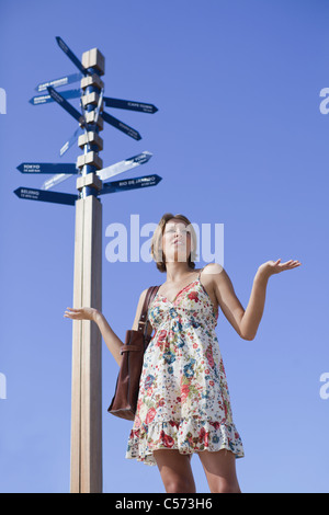 Confused woman at crossroads Stock Photo