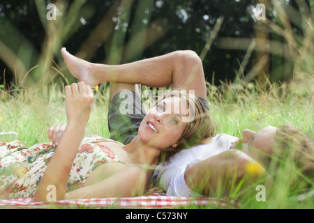 Couple laying in field together Stock Photo