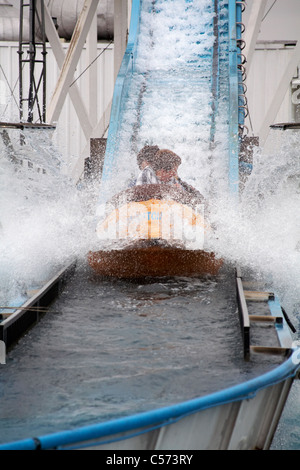 Splashing through the water on attraction ride on Brighton Pier in May Stock Photo