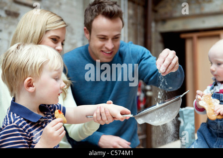 Family baking together in kitchen Stock Photo