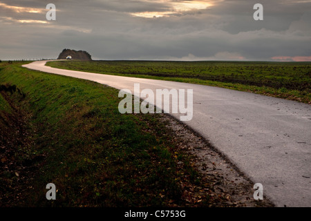 The Netherlands, Ootmarsum. Road at sunset. Car. Stock Photo