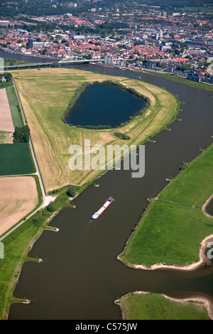 The Netherlands, Deventer, Cargo boat in IJssel River. Aerial. Stock Photo