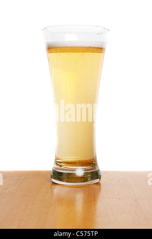 A pilsner glass filled to the top with fresh beer isolated over white. Stock Photo