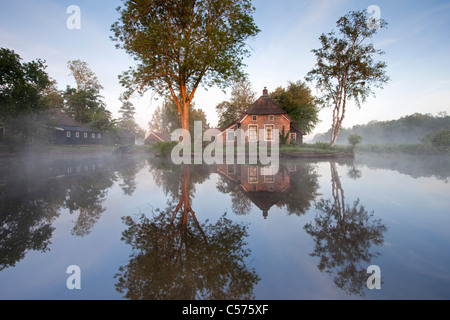 The Netherlands, Dwarsgracht, near Giethoorn. Village with almost only waterways. House at sunrise. Stock Photo
