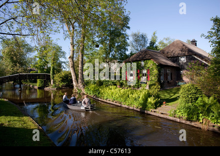 The Netherlands, Giethoorn, Village with almost only waterways. Tourists enjoying boat ride. Stock Photo