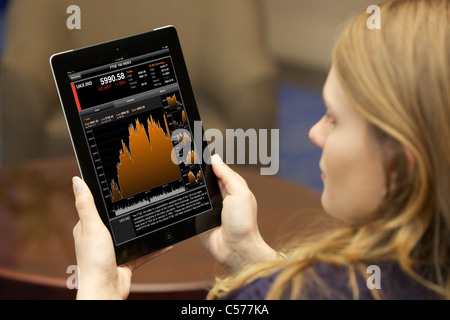Close up view of a woman checking stock market with Bloomberg finance application on an iPad 2 Stock Photo