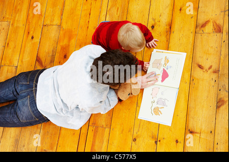 Father and son reading together Stock Photo