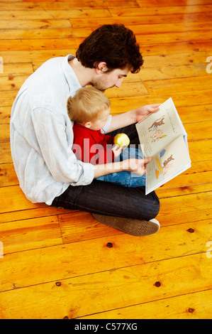 Father and son reading together Stock Photo