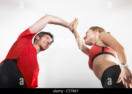 Couple in running gear high fiving Stock Photo