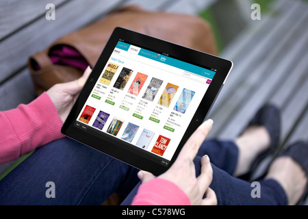 Close up view of a woman browsing Kobo online book store app on an iPad 2 Stock Photo