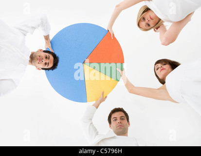 People holding pie chart Stock Photo