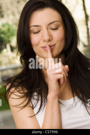Woman holding finger to her lips