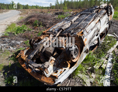 Crashed and burned stolen car in the forest , Finland Stock Photo