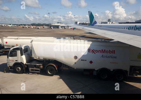 exxon mobil jet fuel refuelling tankers refuel an air canada 737 passenger aircraft at dublin airport Stock Photo