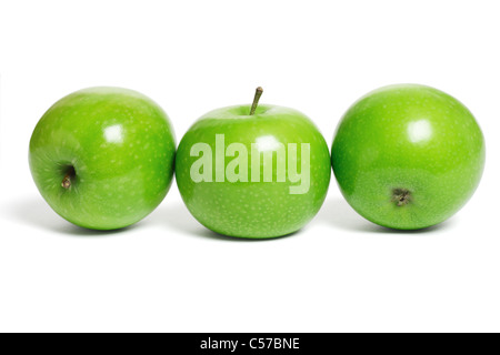 Three fresh green apples in a row on white background Stock Photo