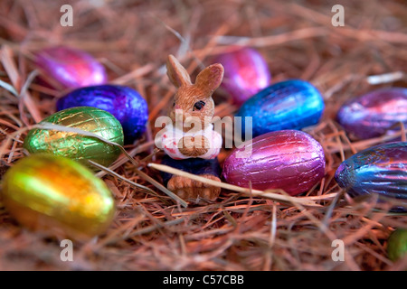 an Easter bunny with Easter eggs in a nest of straw Stock Photo