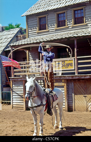 Wild West show Disney World Florida USA with a show cowboy standing on a horses back and twirling a lasso. Stock Photo