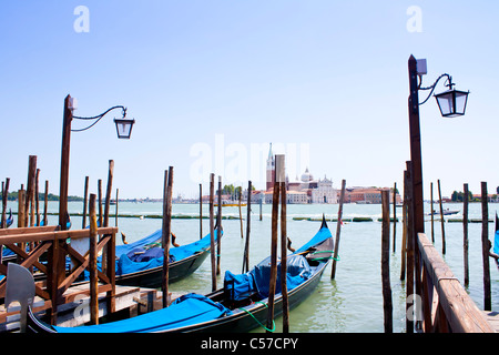 Several gondolas in Venice with view over canal Stock Photo