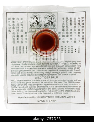 Jar of Wild Tiger balm and instructions manufactured by Liu Uaily Need Chemical Works in China. EDITORIAL ONLY Stock Photo