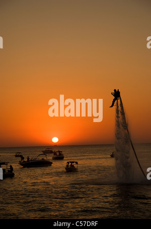 a man showboats using a water jet pack along the  world famous San Antonio Sunset strip Stock Photo