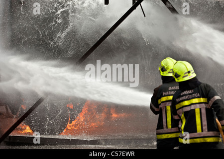 The Netherlands, Rotterdam, Multidisciplinary training center of Falck emergency. Fireman learning to extinguish fire. Stock Photo