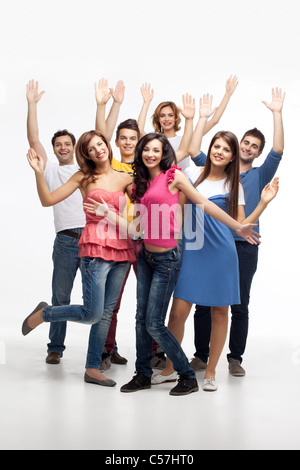 group of fun friends posing with hands in the air  Stock Photo