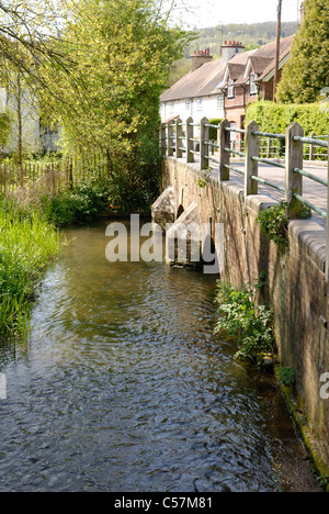 The River Darent flowing beside the road and under the bridge at the village of Shoreham. Kent. England Stock Photo