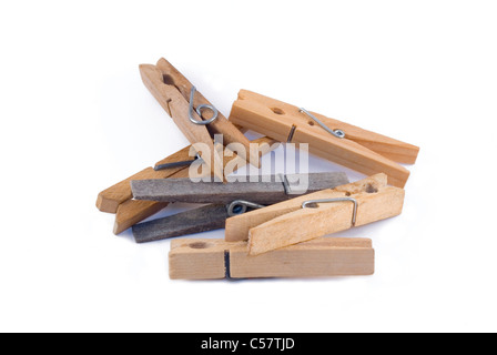 A pile of six ordinary clothes pegs isolated on a white background. Stock Photo