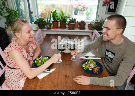 Couple in love enjoys romantic dinner with a glass of wine Stock Photo