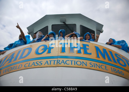 tourists getting wet in blue plastic waterproof ponchos at the maid of the mist niagara falls ontario canada Stock Photo