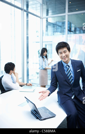 woman doing presentation to people in meeting room Stock Photo