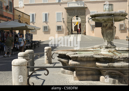 Castel Gandolfo main square with fountain and guarded Vatican building Stock Photo