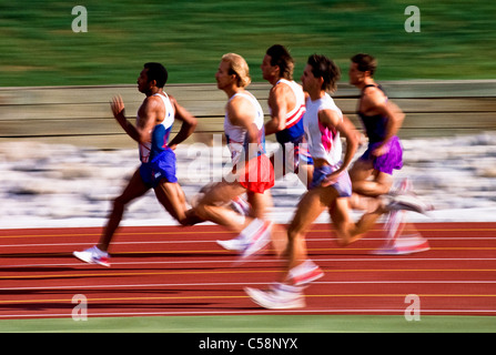 Male runners competing in a track race. Stock Photo