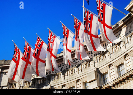 Royal Navy white ensign flags flying from Admiralty Arch in London, UK, on a sunny Summer day. Stock Photo