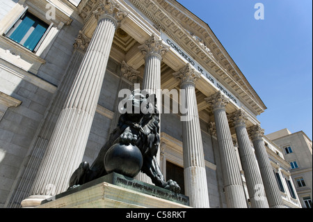 Lion statue outside the Palacio de las Cortes where the Congress of Deputies meets, Madrid, Spain Stock Photo
