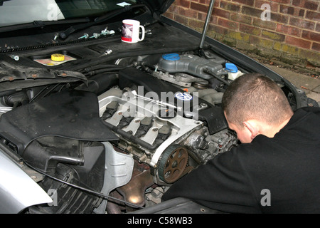 A Motor Technician in the Process of changing a VW Timing Belt Stock Photo