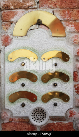 An intercom doorbell panel on the brick wall Stock Photo