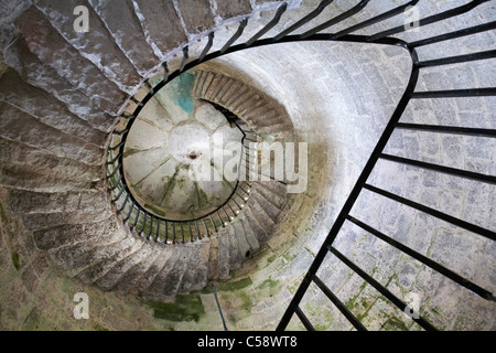 looking up underneath the spiral staircase leading to the top of Old Light lighthouse on Lundy Island, Devon, England UK in March - concept of vertigo Stock Photo