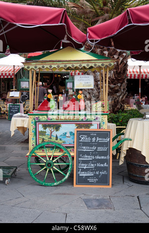 An old ice cream cart as a feature outside a restaurant in Puerto de la Cruz, Tenerife, Canary Islands, Spain Stock Photo