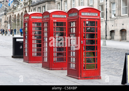 Three old fashioned British red telephone boxes on Edinburgh's High Street (Royal Mile) Stock Photo