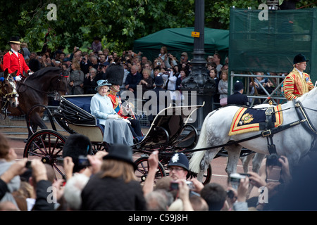 The Queen Elizabeth II and The Duke of Edinburgh leaves Trooping the Color ceremony trough streets crowded of spectators Stock Photo