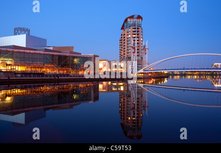 Lowry Bridge illuminated at twilight, Lowry Theatre, Salford quays, Greater Manchester, England Stock Photo