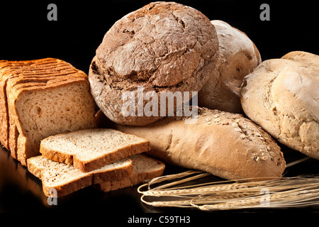 Assortment of baked bread on black background Stock Photo