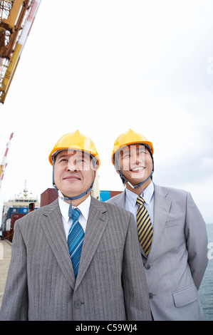 Close-up of Two architects wearing hardhat on dock Stock Photo