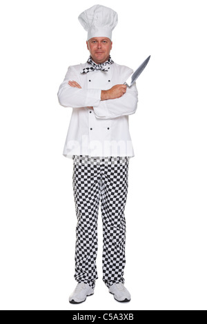 Photo of a chef in uniform with his arms folded holding a knife isolated on a white background. Stock Photo