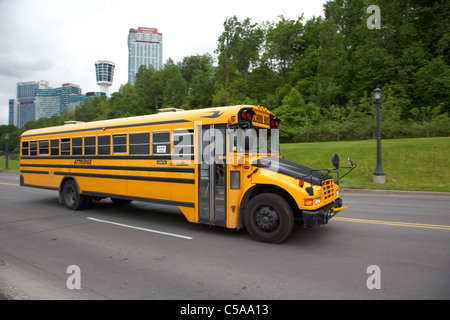 yellow bluebird canadian school bus on road at niagara falls - motion blur panned Stock Photo