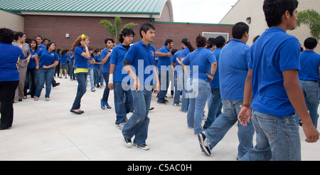 Groups of high school students mingle in courtyard during change of class at South Texas school Stock Photo
