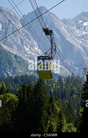A mountain gondola / cable car on its way from the cable car station at the summit of Zugspitze to Eibsee, Bavaria, Germany Stock Photo