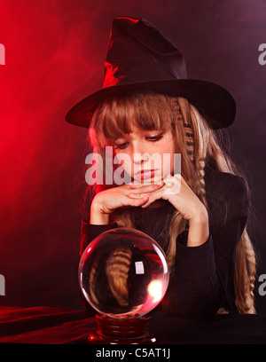 Little girl witch holding crystal ball. Stock Photo